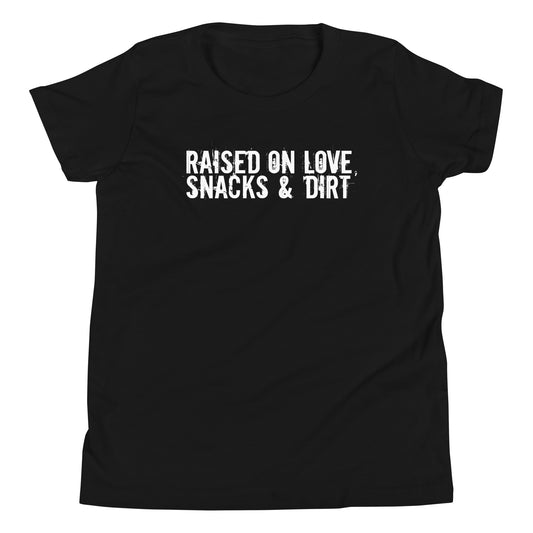 Black t-shirt with white text 'Raised on Love, Snacks & Dirt' in a grungy font