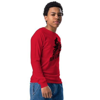 Child wearing a red long-sleeve shirt with black dirt bike graphic and 'Ride Dirty' text